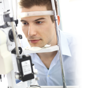 Man in a slit lamp going through a LASIK consultation